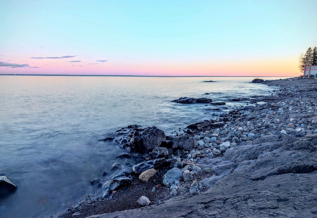 Waves lap on a rocky Lake Superior Shoreline. 